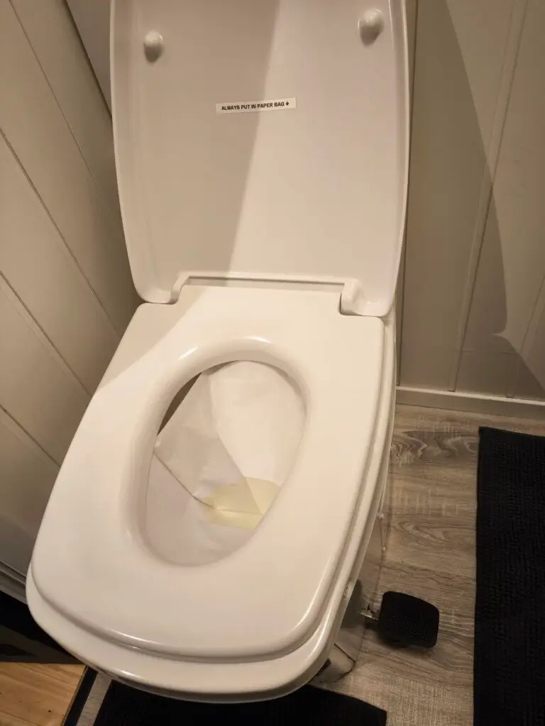 Use black pedal on the right side for the paper bag to fall down in the toilet.